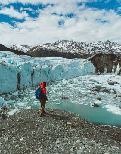 Man standing in front of Blue Wall, Spencer Glacier